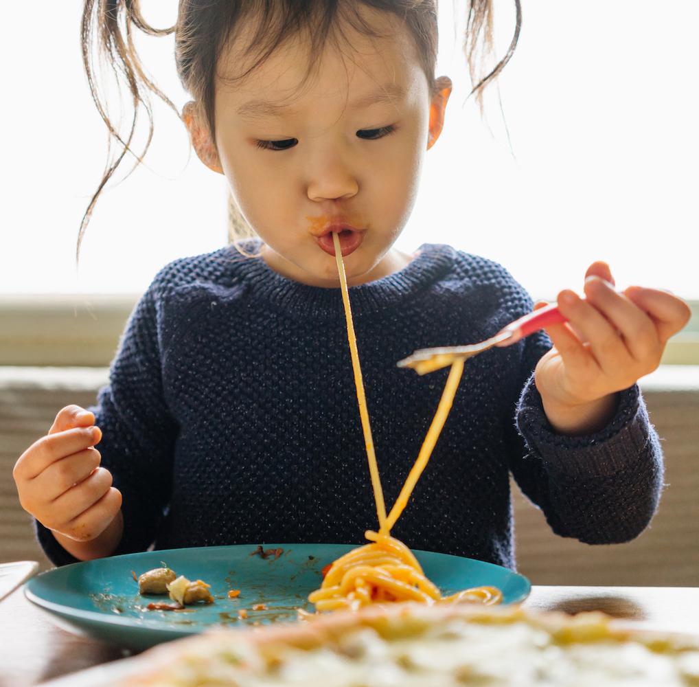 Asian girl eating noodles
